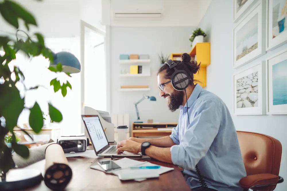 Man met headset zittend aan bureau